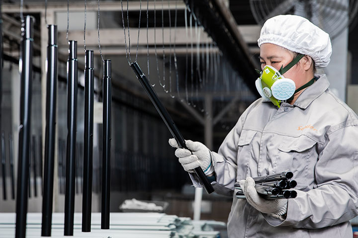 a female worker is inspecting the product's quality and performance