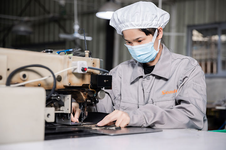 a female worker is sewing products