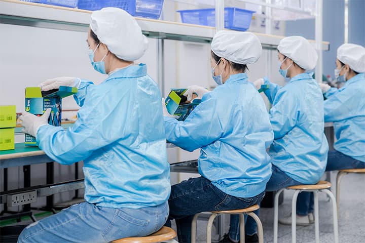 a team of workers is packaging products