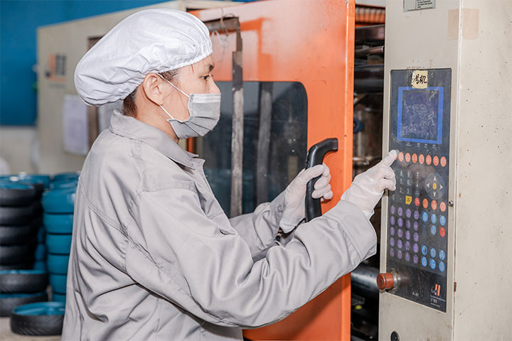 a female worker is operating the CNC machine