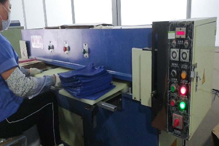 a female worker is using the hydraulic cutting machine